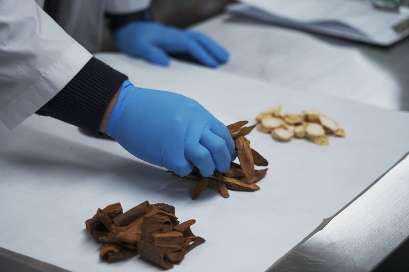 A gloved worker sorting materials at a JAIMDANG facility in Paju